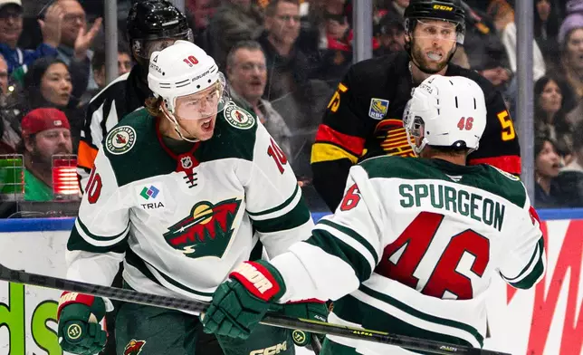 Minnesota Wild's Bobby Brink (10) celebrates with Jared Sturgeon (46) after scoring a goal during the second period of an NHL hockey game, in Vancouver, British Columbia, Sunday, Oct. 25, 2026. (Jacob Mallari/The Canadian Press via AP)