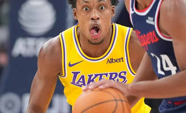 Los Angeles Clippers guard Cam Christie, right, dribbles as Los Angeles Lakers guard Collin Sexton defends during the first half of an NBA basketball game Wednesday, Oct. 28, 2026, in Inglewood, Calif. (AP Photo/Mark J. Terrill)