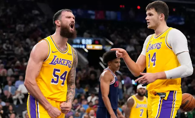 Los Angeles Lakers forward Sandro Mamukelashvili, left, celebrates with center Walker Kessler after scoring during the first half of an NBA basketball game against the Los Angeles Clippers, Wednesday, Oct. 28, 2026, in Inglewood, Calif. (AP Photo/Mark J. Terrill)