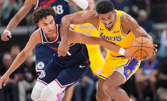 Los Angeles Clippers guard Keaton Wagler, left, and Los Angeles Lakers guard Quentin Grimes go after a loose ball during the first half of an NBA basketball game Wednesday, Oct. 28, 2026, in Inglewood, Calif. (AP Photo/Mark J. Terrill)