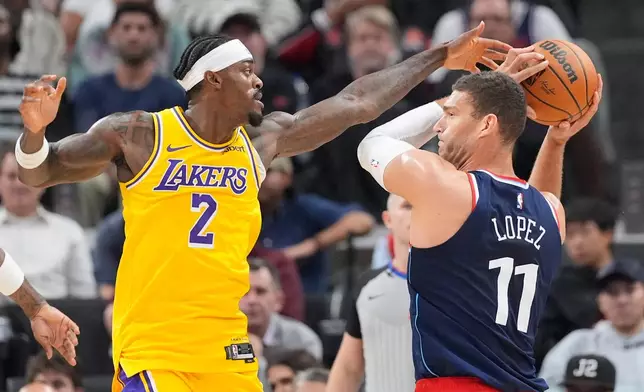 Los Angeles Clippers center Brook Lopez, right, tries to pass while under pressure from Los Angeles Lakers forward Jarred Vanderbilt during the first half of an NBA basketball game Wednesday, Oct. 28, 2026, in Inglewood, Calif. (AP Photo/Mark J. Terrill)