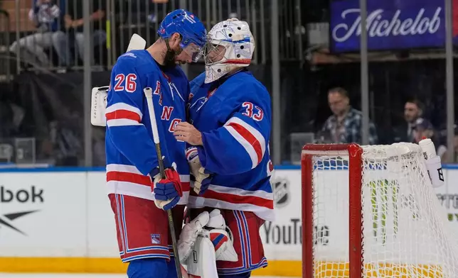 New York Rangers goaltender Dylan Garand, right, celebrates with Marcus Pettersson (26) after an NHL hockey game against the Tampa Bay Lightning in New York, Tuesday, Oct. 13, 2026. (AP Photo/Seth Wenig)