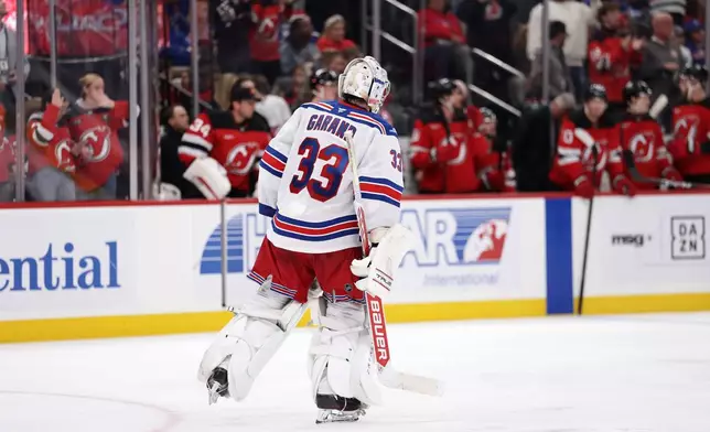 New York Rangers goalie Dylan Garand skates to the bench as he is replaced during the second period of an NHL hockey game against the New Jersey Devils, Thursday, Oct. 15, 2026, in Newark, N.J. (AP Photo/Adam Hunger)