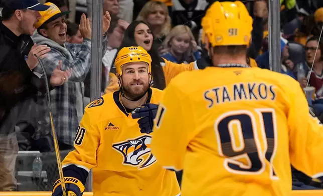 Nashville Predators center Ryan O'Reilly, left, celebrates his goal with Steven Stamkos (91) during the second period of an NHL hockey game Sunday, Oct. 25, 2026, in Nashville, Tenn. (AP Photo/George Walker IV)