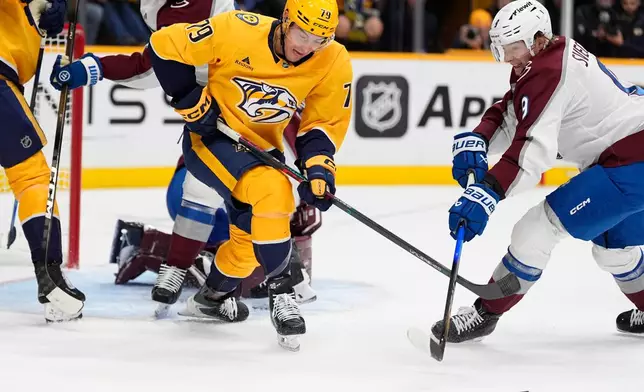 Nashville Predators center Ross Colton (79) chases the puck puck past Colorado Avalanche center Fedor Svechkov (9) during the second period of an NHL hockey game Sunday, Oct. 25, 2026, in Nashville, Tenn. (AP Photo/George Walker IV)