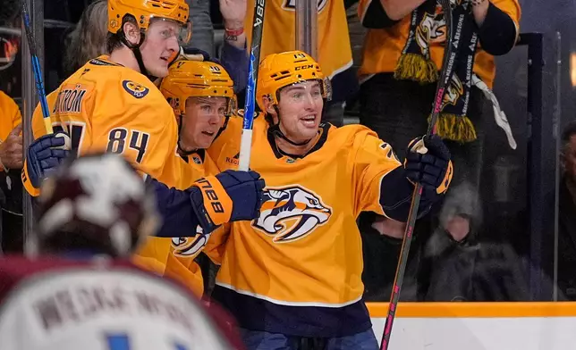 Nashville Predators center Jack Drury, middle, celebrates his goal with Adam Edstrom (84) and Ross Colton, right, during the second period of an NHL hockey game against the Colorado Avalanche, Sunday, Oct. 25, 2026, in Nashville, Tenn. (AP Photo/George Walker IV)