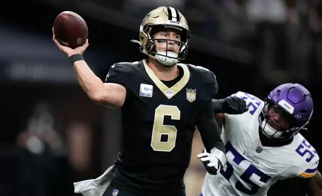 New Orleans Saints quarterback Tyler Shough (6) passes while being pressured by Minnesota Vikings linebacker Eric Wilson (55) during the first half of an NFL football game in New Orleans, Sunday, Oct. 11, 2026. (AP Photo/Gerald Herbert)