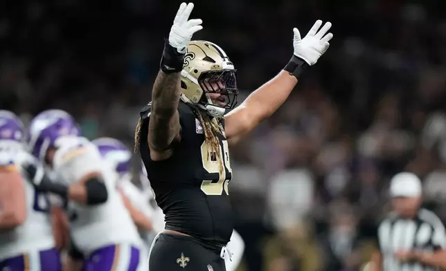 New Orleans Saints defensive end Chase Young gestures toward fans during the first half of an NFL football game against the Minnesota Vikings in New Orleans, Sunday, Oct. 11, 2026. (AP Photo/Gerald Herbert)