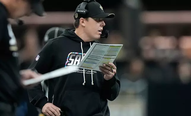 New Orleans Saints head coach Kellen Moore watches from the sideline during the second half of an NFL football game against the Minnesota Vikings in New Orleans, Sunday, Oct. 11, 2026. (AP Photo/Gerald Herbert)
