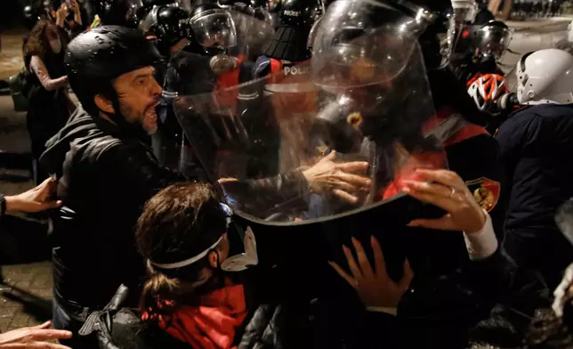 Riot police clash with anti-government protesters in Tirana, Albania, late Tuesday, Oct. 20, 2026. (AP Photo/Boris Grdanoski)