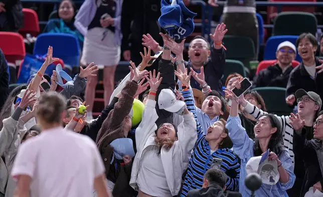 Germany's Alexander Zverev throws his towel to fans after winning against Australia's Alex De Minaur during the men's singles quarterfinals match at the Shanghai Masters tennis tournament in Shanghai, China, Thursday, Oct. 15, 2026. (AP Photo/Andy Wong)