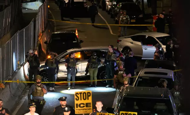 FBI agents gather around the scene of a shooting on Thursday, Oct. 8, 2026, in New York. (AP Photo/Seth Wenig)