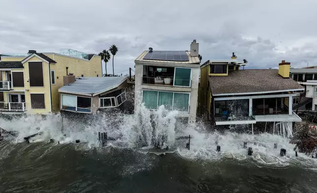 Waves from post-tropical cyclone Rachel crash into beachfront homes in Long Beach, Calif., Monday, Oct. 12, 2026. (AP Photo/Jae C. Hong)