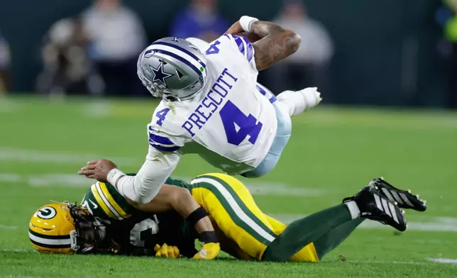 Green Bay Packers' Evan Williams stops Dallas Cowboys' Dak Prescott during the second half of an NFL football game in Green Bay, Wis., Sunday, Oct. 18, 2026. (AP Photo/Matt Ludtke)