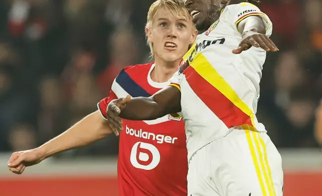Lens' Amadou Haidara, right, heads the ball ahead of Lille's Hakon Haraldsson during the French League One soccer match between Lille and Lens in Lille, France, Friday, Oct. 30, 2026. (AP Photo/Jean-Francois Badias)