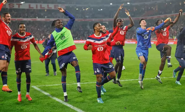 Lille players celebrate their victory at the French League One soccer match between Lille and Lens in Lille, France, Friday, Oct. 30, 2026. (AP Photo/Jean-Francois Badias)