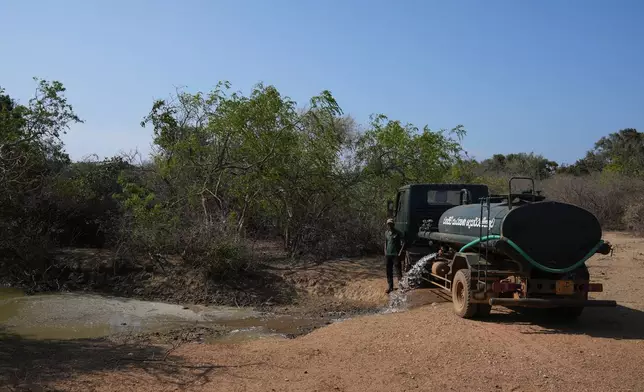 A water tanker fills a pond for animals during a drought in Yala National Park in Yala, Sri Lanka, Friday, Sept. 11, 2026. (AP Photo/Eranga Jayawardena)