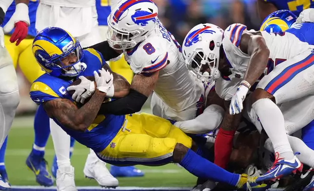 Los Angeles Rams running back Kyren Williams, left, goes in for a touchdown as Buffalo Bills linebacker Terrel Bernard defends during the second half of an NFL football game, Monday, Oct. 12, 2026, in Inglewood, Calif. (AP Photo/Scott Strazzante)