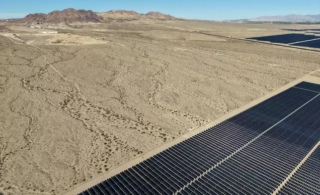 Land for a proposed data center is seen near solar panels Friday, Oct. 2, 2026, near Boulder City, Nev. (AP Photo/John Locher)