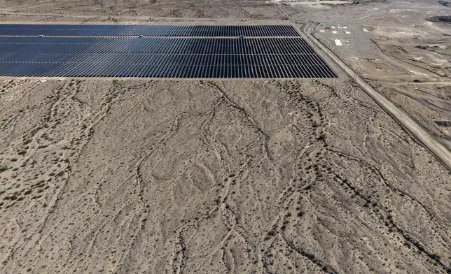 Land for a proposed data center is seen near solar panels Friday, Oct. 2, 2026, near Boulder City, Nev. (AP Photo/John Locher)