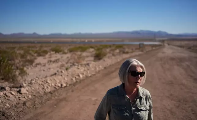 Janelle Sorenson stands beside land for a proposed data center Friday, Oct. 2, 2026, near Boulder City, Nev. (AP Photo/John Locher)