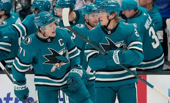 San Jose Sharks center Will Smith (2) celebrates with teammate Macklin Celebrini (71) after scoring a goal against the Florida Panthers during the second period of an NHL hockey game in San Jose, Calif., Thursday, Oct. 1, 2026. (AP Photo/Tony Avelar)