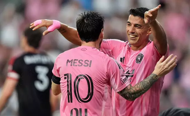 Inter Miami forward Luis Suarez, right, celebrates with forward Lionel Messi after scoring his side's second goal during the first half of an MLS soccer match against D.C. United, Saturday, Oct. 10, 2026, in Miami. (AP Photo/Rebecca Blackwell)