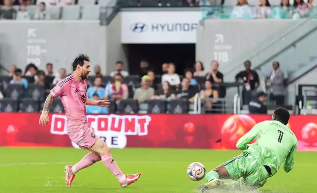 D.C. United goalkeeper Sean Johnson (1) stops a scoring attempt from Inter Miami forward Lionel Messi during the first half of an MLS soccer match, Saturday, Oct. 10, 2026, in Miami. (AP Photo/Rebecca Blackwell)