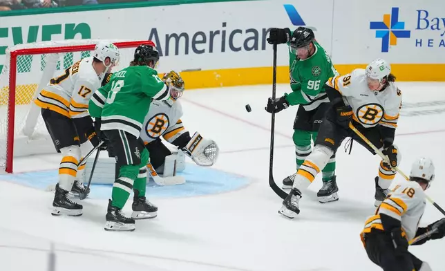 Dallas Stars right wing Mikko Rantanen (96) attacks against Boston Bruins defenseman Nikita Zadorov (91) during the third period of an NHL hockey game Tuesday, Oct. 20, 2026, in Dallas. (AP Photo/Julio Cortez)