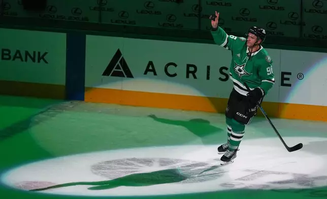 Dallas Stars right wing Mikko Rantanen takes a postgame curtain call after scoring a hat trick against the Boston Bruins during an NHL hockey game Tuesday, Oct. 20, 2026, in Dallas. (AP Photo/Julio Cortez)
