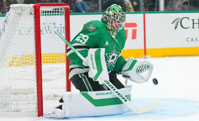 Dallas Stars goaltender Jake Oettinger blocks a shot by the Boston Bruins during the second period of an NHL hockey game Tuesday, Oct. 20, 2026, in Dallas. (AP Photo/Julio Cortez)