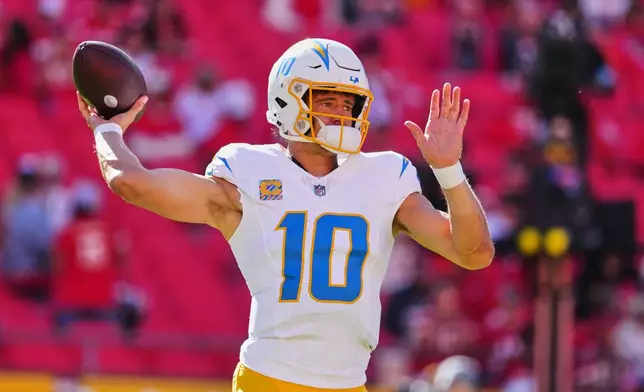 Los Angeles Chargers quarterback Justin Herbert warms up before an NFL football game against the Kansas City Chiefs in Kansas City, Mo., Sunday, Oct. 18, 2026. (AP Photo/Ed Zurga)