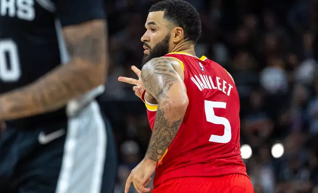 Houston Rockets guard Fred Vanvleet (5) celebrates after scoring against the San Antonio Spurs during the second half of an NBA basketball game in Austin, Texas, Friday, Oct. 23, 2026. (AP Photo/Stephen Spillman)