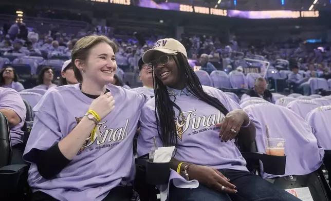 Golden State Valkyries fans Kendall Christmas-Miller, left, smiles with her wife, Shaunice Christmas-Miller, while being interviewed before Game 5 of the WNBA basketball finals between the Valkyries and the Atlanta Dream, Monday, Oct. 26, 2026, in San Francisco. (AP Photo/Jeff Chiu)