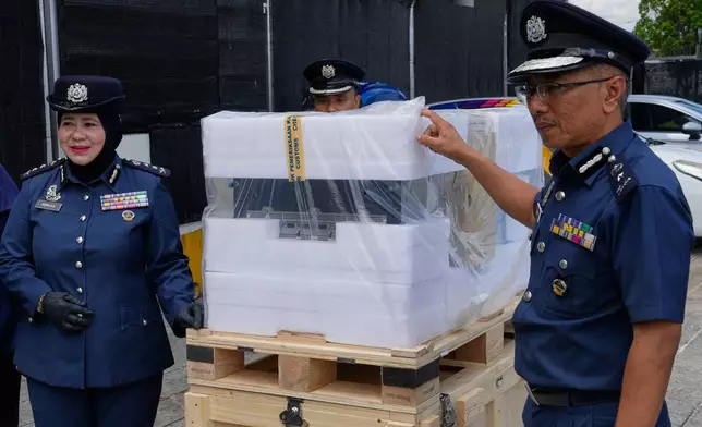 Malaysian customs officers show a seized server containing advanced artificial intelligence chips to the media at its headquarters in Sepang, Malaysia, Wednesday, Oct. 28, 2026. (AP Photo/Vincent Thian)