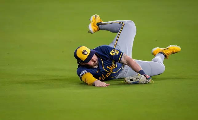 Milwaukee Brewers center fielder Garrett Mitchell catches a fly out hit by Los Angeles Dodgers second baseman Tommy Edman during the fifth inning of Game 3 of baseball's National League Championship Series between the Milwaukee Brewers and the Los Angeles Dodgers, Wednesday, Oct. 14, 2026, in Los Angeles. (AP Photo/Mark J. Terrill)