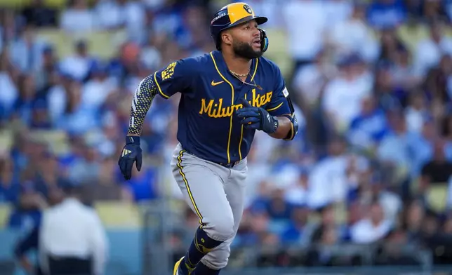 Milwaukee Brewers left fielder Jackson Chourio watches his solo home run take flight during the first inning of Game 3 of baseball's National League Championship Series between the Milwaukee Brewers and the Los Angeles Dodgers, Wednesday, Oct. 14, 2026, in Los Angeles. (AP Photo/Gregory Bull)