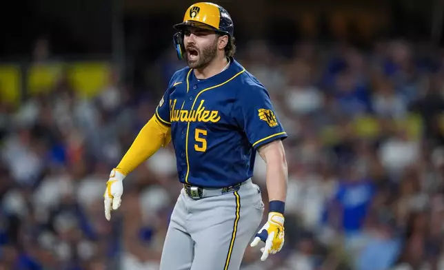 Milwaukee Brewers center fielder Garrett Mitchell yells towards his dugout after hitting a solo home run during the seventh inning of Game 3 of baseball's National League Championship Series between the Milwaukee Brewers and the Los Angeles Dodgers, Wednesday, Oct. 14, 2026, in Los Angeles. (AP Photo/Gregory Bull)