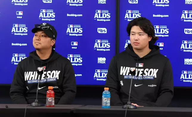 Chicago White Sox first baseman Munetaka Murakami, right, sits with interpreter Kenzo Yagi, left, during a postgame news conference after a win over the Cleveland Guardians in Game 1 of baseball's American League Division Series, Saturday, Oct. 3, 2026, in Cleveland. (AP Photo/Tim Phillis)