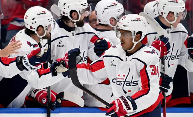 Washington Capitals center Justin Sourdif (34) celebrates his goal during the second period of an NHL hockey game against the Tampa Bay Lightning Saturday, Oct. 3, 2026, in Tampa, Fla. (AP Photo/Jason Behnken)