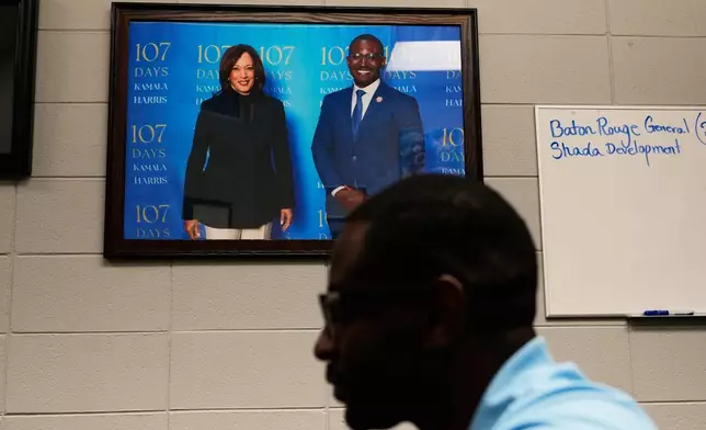 Anthony Kenney, District 2 councilman for the Baton Rouge Metropolitan Council, speaks in his office underneath a photo of him with former Vice President Kamala Harris, in the Scotlandville section of Baton Rouge, La., Monday, Sept. 14, 2026. (AP Photo/Gerald Herbert)