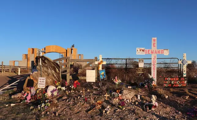 FILE - Crosses, flowers and other mementos are displayed outside Jeffrey Epstein's former Zorro Ranch near Stanley, N.M., on April 3, 2026. (AP Photo/Savannah Peters, File)