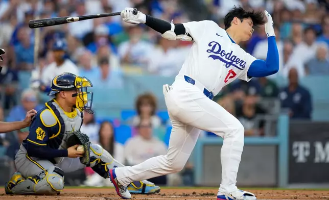 Los Angeles Dodgers designated hitter Shohei Ohtani strikes out as Milwaukee Brewers catcher William Contreras catches the ball during the first inning of Game 4 of baseball's National League Championship Series between the Milwaukee Brewers and the Los Angeles Dodgers, Thursday, Oct. 15, 2026, in Los Angeles. (AP Photo/Ashley Landis)
