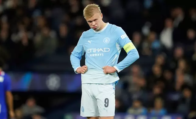 Manchester City's Erling Haaland reacts after PSG's Maghnes Akliouche scoree their fourth goal during the Champions League opening phase soccer match between Manchester City and Paris Saint-Germain in Manchester, England, Wednesday, Oct. 14, 2026. (AP Photo/Dave Thompson)