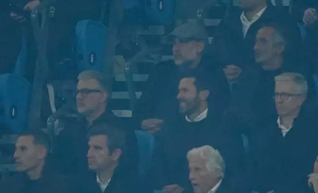 Manchester City former manager Pep Guardiola, center top attends the Champions League opening phase soccer match between Manchester City and Paris Saint-Germain in Manchester, England, Wednesday, Oct. 14, 2026. (AP Photo/Dave Thompson)
