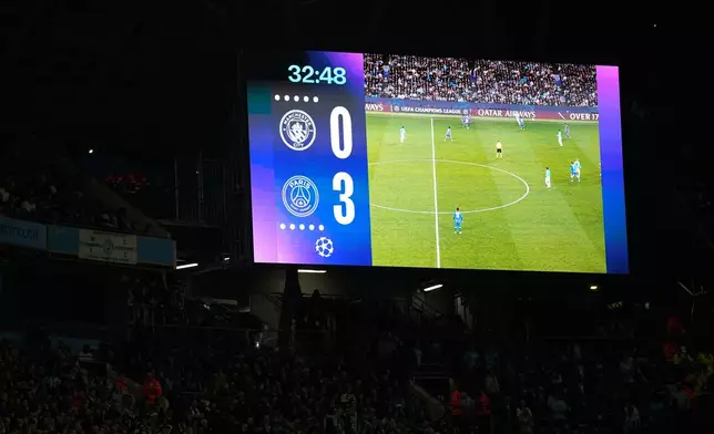 The result is displayed on the screen after PSG's Vitinha scored their third goal during the Champions League opening phase soccer match between Manchester City and Paris Saint-Germain in Manchester, England, Wednesday, Oct. 14, 2026. (AP Photo/Dave Thompson)