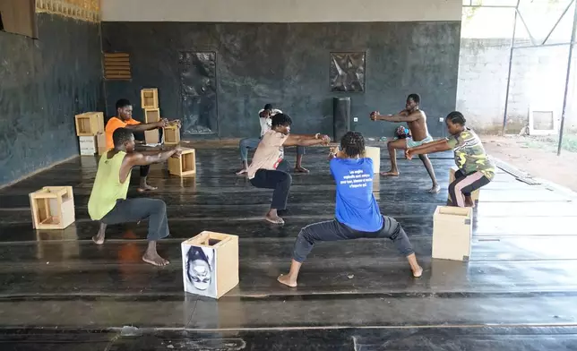 Members of the Fientan Compagnie take part in a physical training session at the headquarters of the Au-delà de l'Handicap Association in Bobo-Dioulasso, Burkina Faso, Tuesday, May 5, 2026. (AP Photo/Elia Borras)