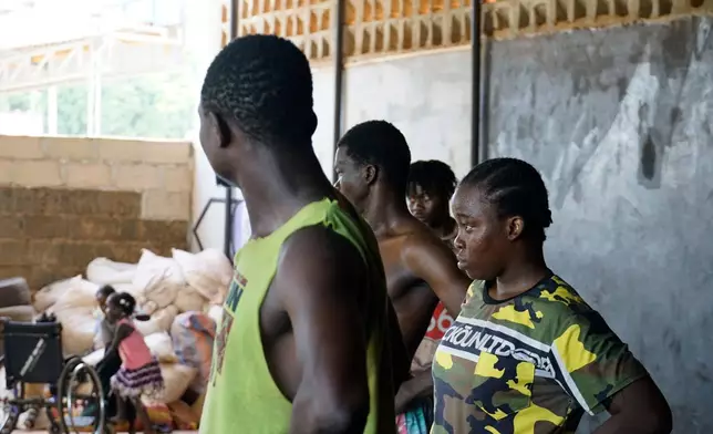 Burkinabé dancer Ouaramata Sanou, with her colleagues, looks to Yaya Sanou, who gives them guidance in Bobo-Dioulasso, Burkina Faso, Tuesday, May 5, 2026. (AP Photo/Elia Borras)