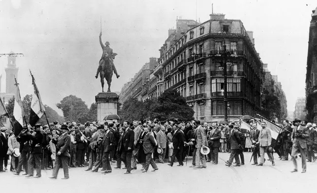 FILE - French war veterans march past the Washington Monument on the Place d'Iena in Paris, on July 19, 1926, in protest against the U.S. debt terms. (AP Photo, File)