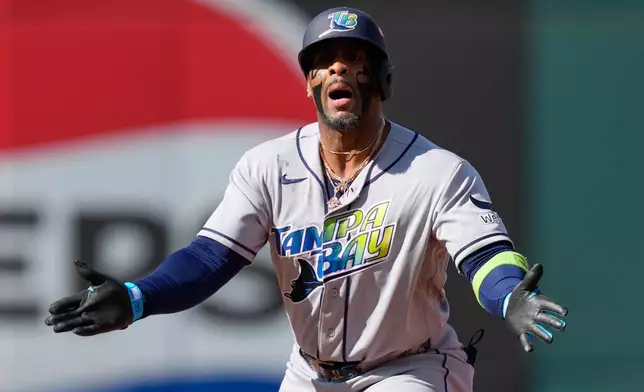 Tampa Bay Rays' Yandy Díaz celebrates a double against the Cleveland Guardians during the fourth inning in Game 3 of an American League Championship Series baseball game in Cleveland, Thursday, Oct. 15, 2026. (AP Photo/David J. Phillip)